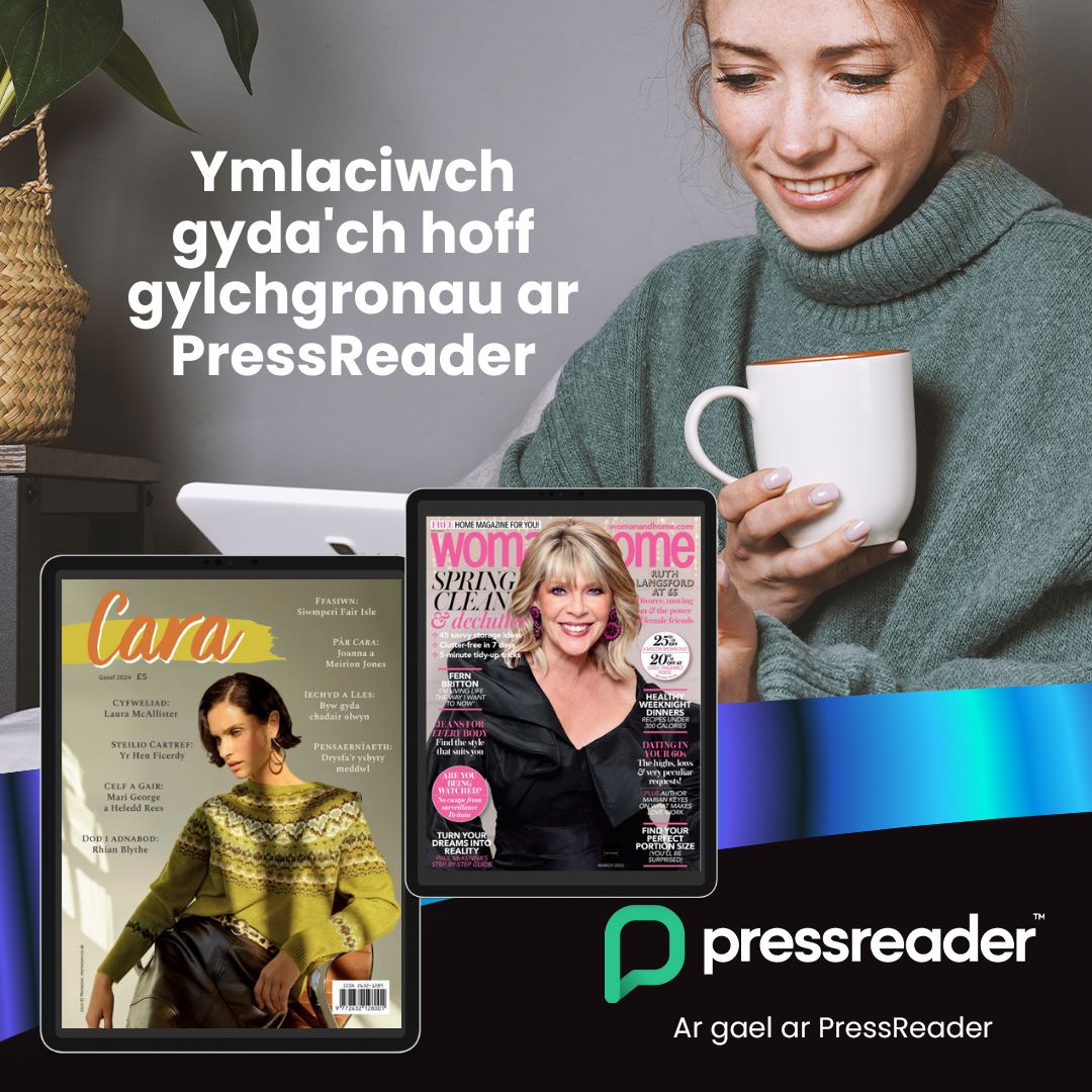 Woman holding a mug and looking down at a tablet